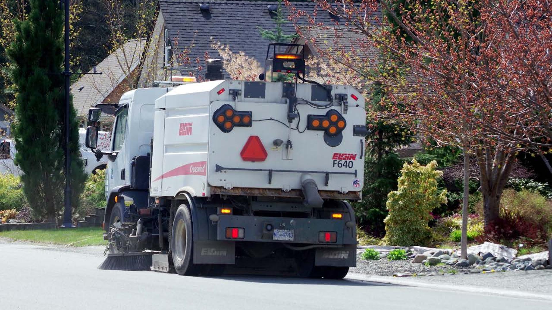 Street sweeper moving along a road