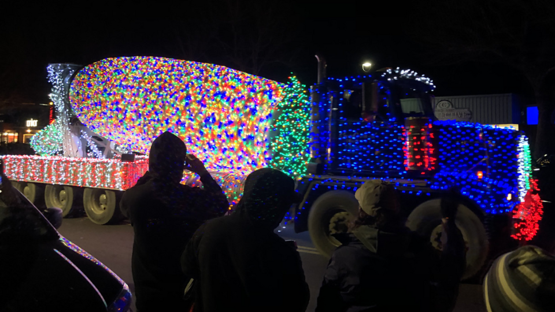 Illuminated cement truck participating in the Big Truck Parade in downtown Campbell River at night, decorated with bright lights.