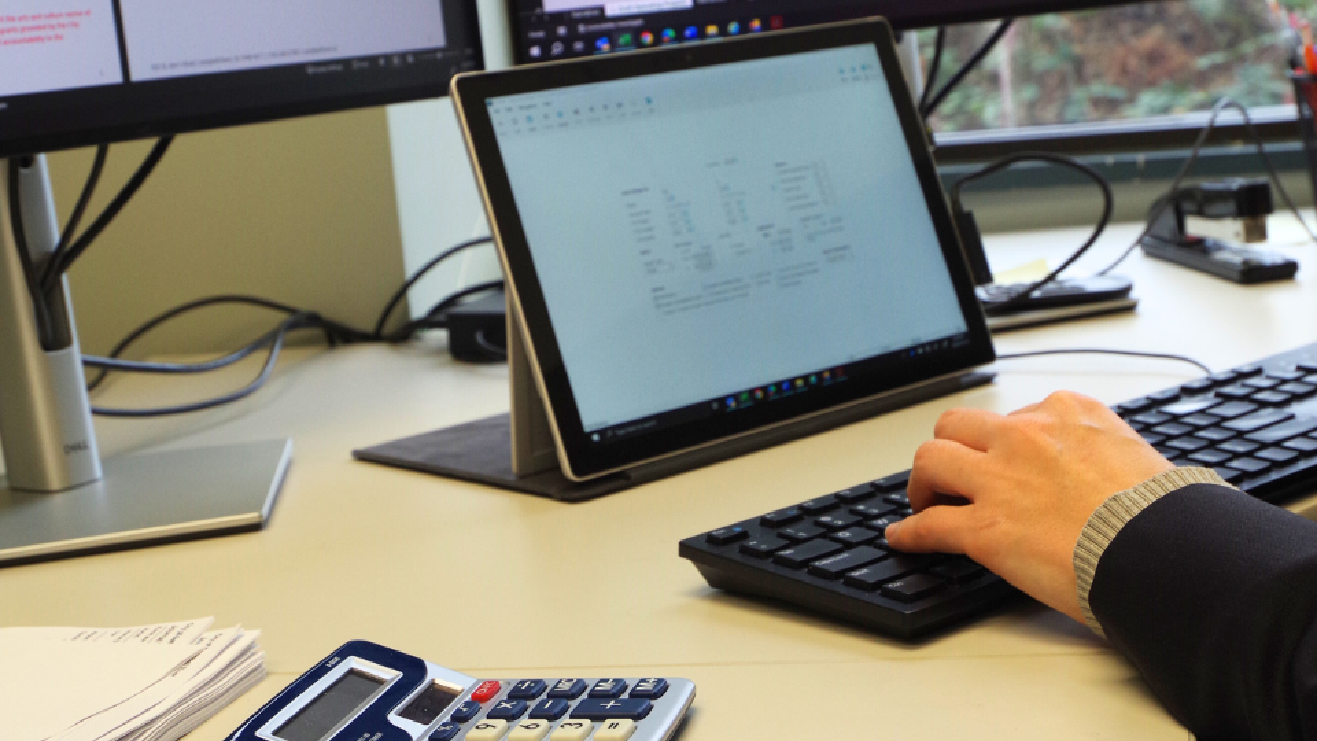 person typing on a computer searching for a document.