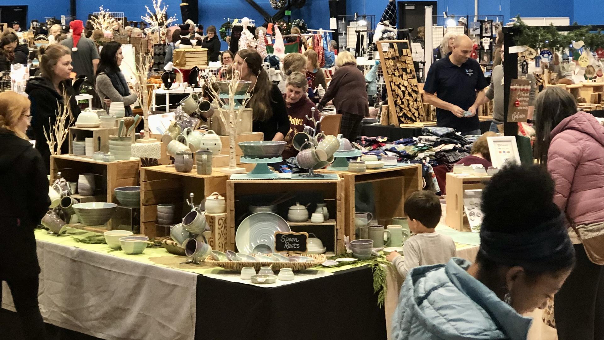 Vendors at the Toy and Craft Fair with shoppers browsing.