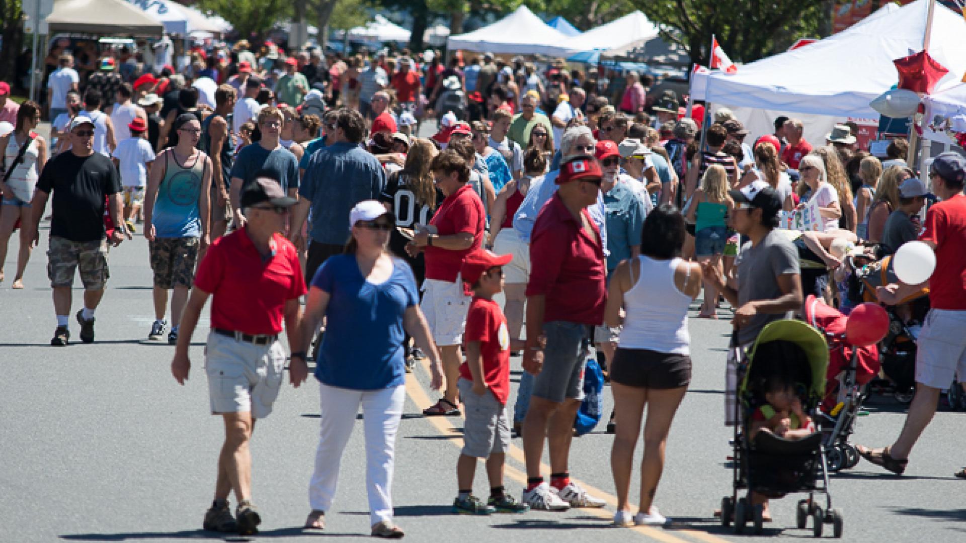 Downtown Campbell River with people dressed in red and white celebrating Canada Day.