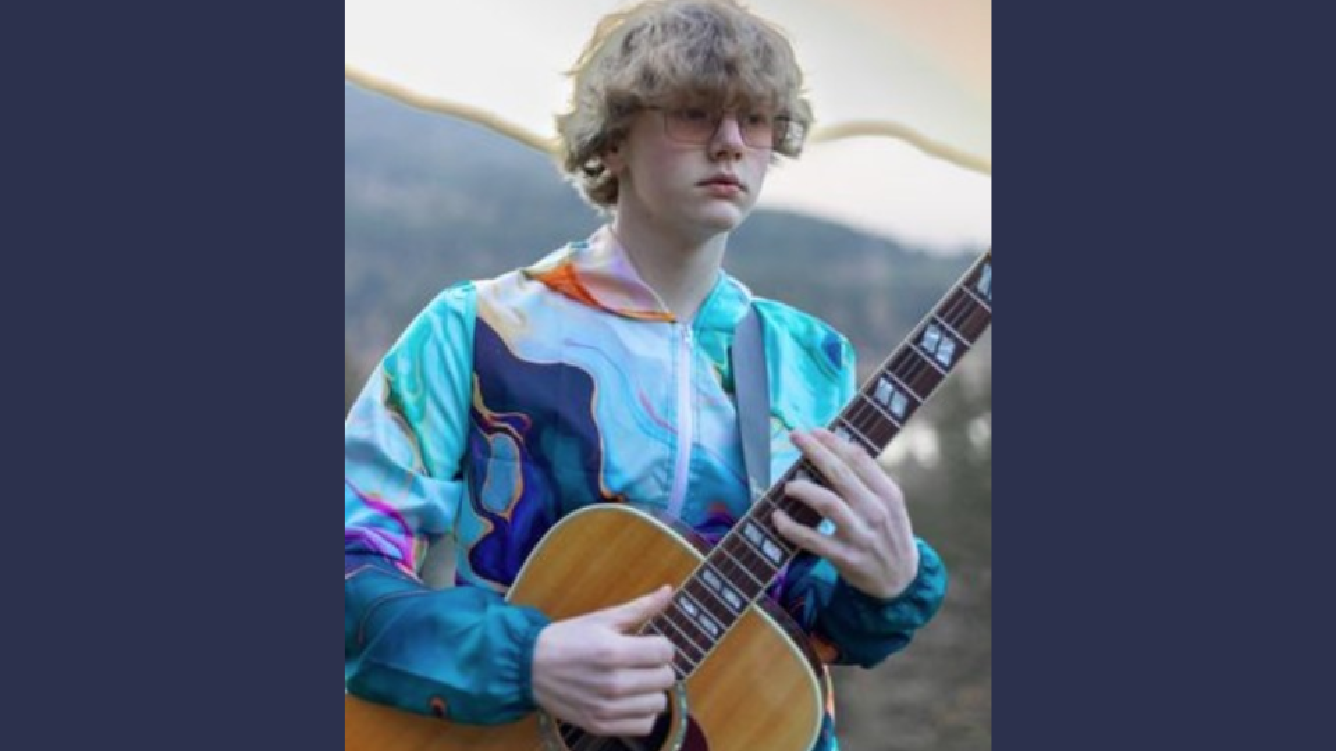 Malakai playing guitar.