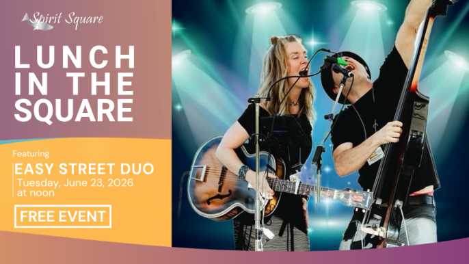 Easy Street Due sing loud into a microphone showing high energy while holding guitars.
