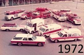 Vintage fire trucks and ambulances parked in a circle.