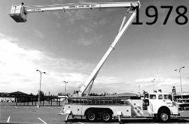 Black-and-white photo of a 1978 fire truck with an extended ladder.