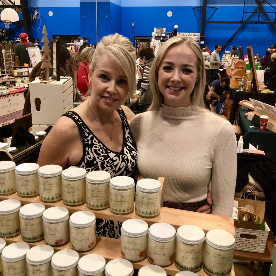 Two vendors at the Toy and Craft Show selling candles.