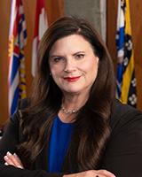 Susan Sinnott, a member of the Council, poses for a photo in a portrait-style format.